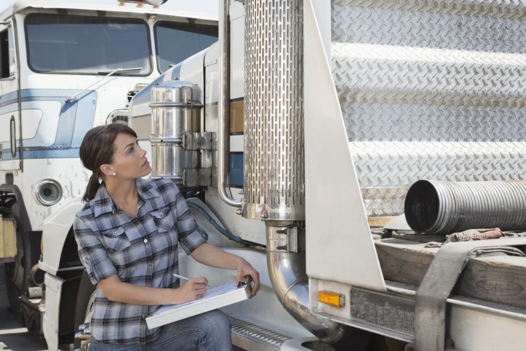 person performing inspection on truck